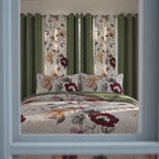 Square video showing the sage green floral quilted bedspread, matching shams, and six coordinating curtain panels in a bedroom.