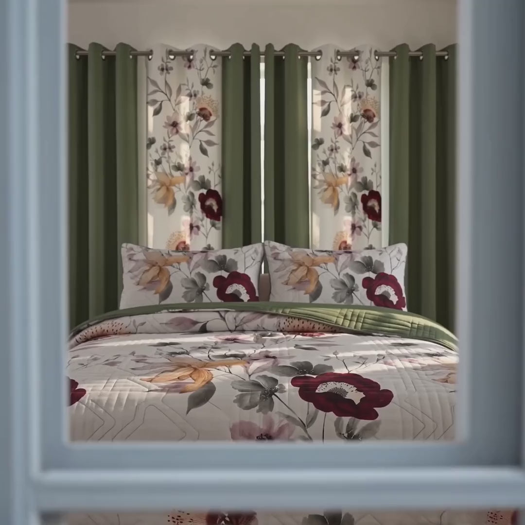 Square video showing the sage green floral quilted bedspread, matching shams, and six coordinating curtain panels in a bedroom.