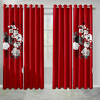 Two red curtain panels with white floral prints and grommet tops.