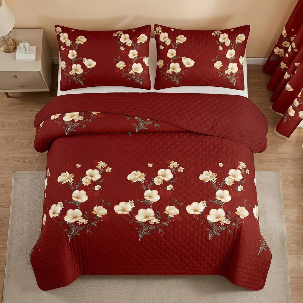 Overhead view of the red and yellow floral quilted bedspread with two matching pillow shams and a folded solid red reverse.